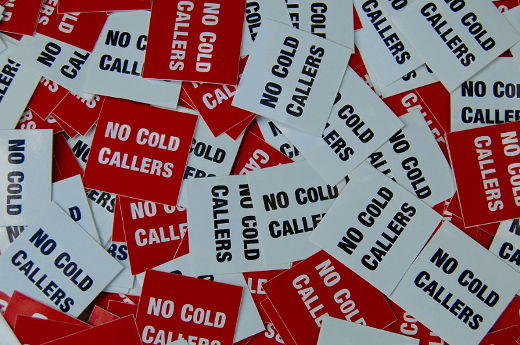 A photo of lots of red and white 'No Cold Callers' stickers.